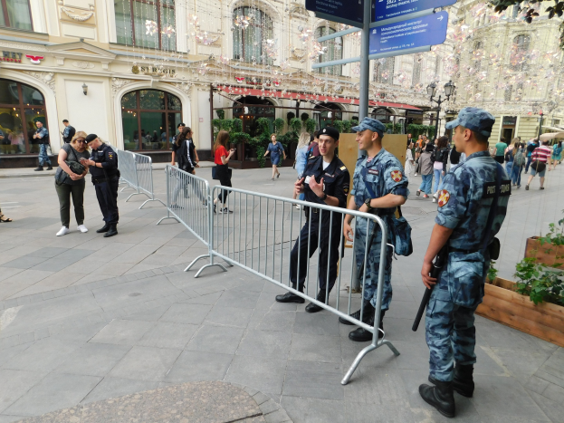 Polizisten in Uniform stehen hinter Absperrungen und blicken auf eine Menge, einige halten Waffen, während einer Anti-Terror-Operation in Wien, Österreich.