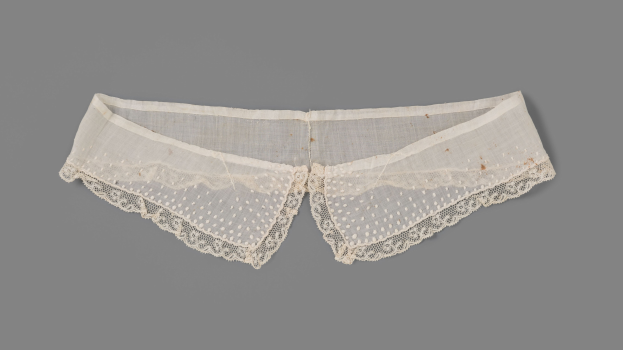 Weiße Spitzenhöschen mit zartem Spitzenbesatz auf grauem Hintergrund.