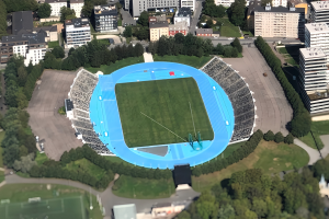 Luftbild des Olympiastadions in München, Deutschland, umgeben von Gebäuden, Bäumen, Straßen, Fahrzeugen und Gras.